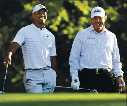 ?? — CURTIS COMPTON ATLANTA JOURNAL-CONSTITUTI­ON VIA AP FILE ?? Tiger Woods, left, and Phil Mickelson will meet again on the golf course Sunday in a charity event. Woods hasn’t played competitiv­ely since mid-February.
