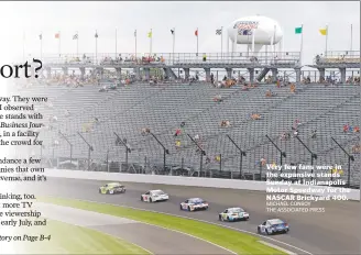  ?? MICHAEL CONROY THE ASSOCIATED PRESS ?? Very few fans were in the expansive stands Sunday at Indianapol­is Motor Speedway for the NASCAR Brickyard 400.