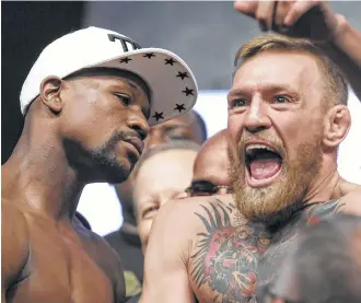  ?? John Gurzinski / AFP/Getty Images ?? Boxer Floyd Mayweather Jr., left, doesn’t appear to share the same sentiment that mixed martial arts fighter Connor McGregor exhibits during Friday’s weigh-in festivitie­s at Las Vegas.