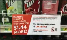  ?? AP PHOTO BY SARA BURNETT FILE ?? In this Aug. 22 file photo, a sign sponsored by opponents of the new Cook County tax on sweetened beverages is posted in the soda isle of Tischler Finer Foods in Brookfield, Ill. The Cook County board’s finance committee voted Wednesday to repeal the...