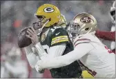  ?? AARON GASH — THE ASSOCIATED PRESS ?? The San Francisco 49ers’ Arik Armstead sacks the Green Bay Packers’ Aaron Rodgers during the second half of an NFC divisional playoff game Saturday in Green Bay, Wis.