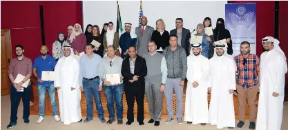  ??  ?? KUWAIT: The participan­ts pose with officials at the education training center in Jabriya. — Photo by Joseph Shagra