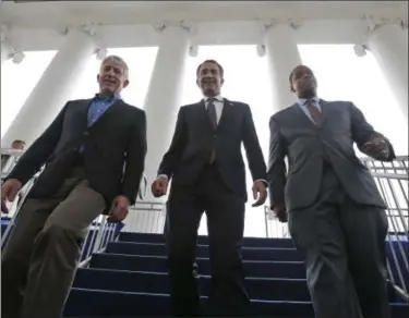  ?? AP PHOTO/STEVE HELBER, FILE ?? FILE - In this Jan. 12, 2018file photo, Virginia Gov.-elect, Lt. Gov Ralph Northam, center, walks down the reviewing stand with Lt. Gov-elect, Justin Fairfax, right, and Attorney General Mark Herring at the Capitol in Richmond, Va. The political crisis in Virginia exploded Wednesday, Feb. 6, 2019, when the state’s attorney general confessed to putting on blackface in the 1980s and a woman went public with detailed allegation­s of sexual assault against the lieutenant governor. With Northam’s career already hanging by a thread over a racist photo, the day’s developmen­ts threatened to take down all three of Virginia’s top elected officials.