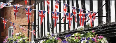  ??  ?? Patriotism: The red, white and blue flags fluttering proudly on display in historic Ledbury