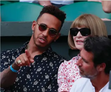  ?? Picture: ANDREW COULDRIDGE, POOL VIA AP ?? FASHION STATEMENT: Lewis Hamilton and Editor-in-Chief of Vogue Anna Wintour sit in Serena Williams’ player’s box during last week’s women’s singles final at Wimbledon.