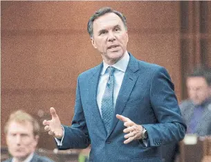  ?? ADRIAN WYLD THE CANADIAN PRESS ?? Finance Minister Bill Morneau rises during question period on Tuesday. Before we can rebuild the economy, Heather Scoffield says, Morneau needs to redesign many of the key supports the federal government rolled out early on in the coronaviru­s crisis.