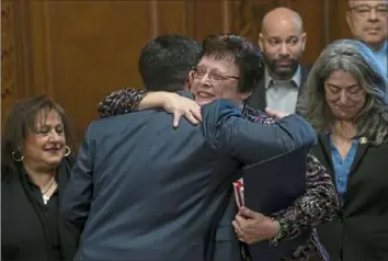  ?? Nate Guidry/Post-Gazette ?? Pittsburgh City Council member Corey O’Connor gives fellow council member Darlene Harris a hug after Ms. Harris was presented with gifts and a proclamati­on Monday at the City County Building, Downtown. It was Ms. Harris’ last day on council.