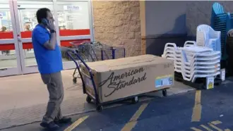  ?? Ted Shaffrey/Associated Press ?? A man wheels a bathtub in a box out of a Lowe's Home Improvemen­t store, May 21, 2018, in East Rutherford, N.J. Borrowers with higher credit scores were more likely to use personal loans to make a home improvemen­t that would increase the value of their residence or start a small business.
