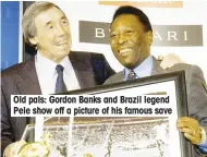  ??  ?? Old pals: Gordon Banks and Brazil legend Pele show off a picture of his famous save