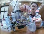  ?? GAO ERQIANG / CHINA DAILY ?? Yu Xinsheng, a graduate of the Shanghai Jiao Tong University, showcases his air motor. He hopes to work at the newly-launched Innovation Center for China-US Youth Exchange at the campus to continue his research.
