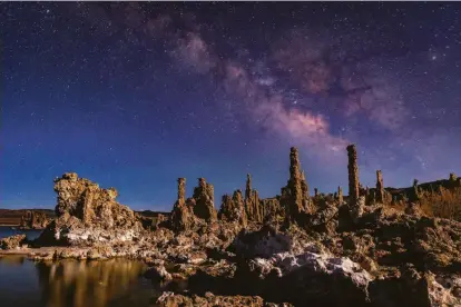  ?? Photos by Carlos Avila Gonzalez / The Chronicle ?? Limestone spires known as tufa towers at Mono Lake are illuminate­d by the moon outside Lee Vining (Mono County).