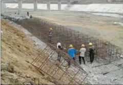  ?? PHAK SEANGLY ?? JICA will be consulting the Environmen­t Ministry on how to better assess the impacts of large-scale developmen­t projects like the Lower Sesan II dam, seen above during 2014 constructi­on.