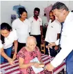  ??  ?? Helpage Executive Director giving a gift to an elderly woman