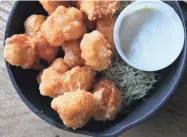  ?? MICHAEL SEARS / MILWAUKEE JOURNAL SENTINEL ?? Cheese curds, such as this deep-fried version from Fuel Cafe in Walker's Point, start out squeaky when they're fresh.