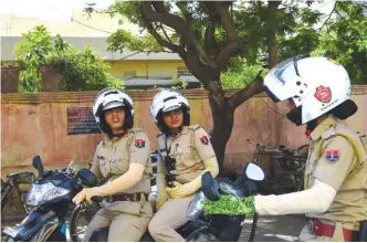  ?? —AFP ?? In this photo taken on June 14, 2017, members of a newly launched female police patrol unit drive through the old city in Jaipur.