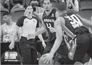  ?? AP Photo/John Locher ?? ■ Referee Natalie Sago, left, works at an NBA summer league basketball game between the Los Angeles Clippers and the Atlanta Hawks on Friday in Las Vegas. Summer league is where players can get noticed by the NBA, and the same is true for referees.