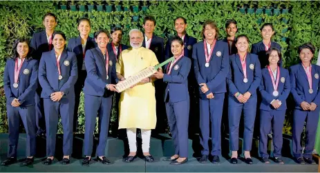  ?? — PTI ?? Prime Minister Narendra Modi poses for a group photograph with the Indian women’s cricket team in New Delhi on Thursday.