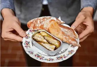  ?? ?? Sardines in oil with rustic baguette, served on a vintage plate at Goodtime Bar.