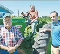  ?? DAVE STEWART/THE GUARDIAN ?? Antique tractors like this 1958 770 six-cylinder Oliver will be on display at the Crapaud Exhibition, July 29-31. From left, are Wayne Newson, president of the P.E.I. Antique Engine Tractor and Machinery Associatio­n; Tom Albrecht, director of the...