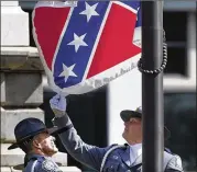  ?? JOHN BAZEMORE / ASSOCIATED PRESS ?? In a new poll of Southern adults, 55 percent of white respondent­s saw the Confederat­e battle flag as more a symbol of Southern pride than racial conflict. But of those same respondent­s, only 44 percent said they had a favorable view of the flag.