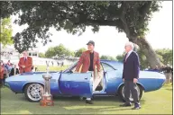  ?? Tom Pennington / Getty Images ?? Kevin Na talks with Charles Schwab after being presented with a fully restored 1973 Dodge Challenger for winning the Charles Schwab Challenge at Colonial Country Club on Sunday in Fort Worth, Texas.