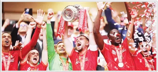  ?? Mailonline ?? RED LIONS... Liverpool players celebrate victory in the FA Cup final at Wembley on Saturday -
