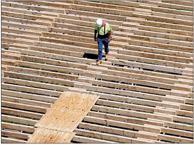  ?? AP ?? A workman walks along a structure being built for the NFL Draft in Nashville, Tenn., last month. Constructi­on payrolls added 49,000 jobs in April although constructi­on spending fell 0.9% the previous month, the Commerce Department said Wednesday.