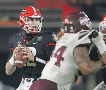  ?? Kevin C. Cox Getty I mages ?? JT DANIELS threw for four touchdowns in his Georgia debut last Saturday against Mississipp­i State, his f irst action since a 2019 injury that led the former f ive- star recruit from Mater Dei to transfer from USC.