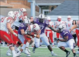  ?? [ANDREA NOALL/DISPATCH] ?? Otterbein’s Christian Johnson is hauled down by Capital’s Kole Carter on a first-half carry, as Kane Murray, far right, and James Zamor close in for the Crusaders. Johnson rushed for 117 yards and two TDs for the Cardinals.