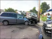  ?? EVAN BRANDT — DIGITAL FIRST MEDIA ?? At right, the driver of the Jeep, who police did not immediatel­y identify, waits to speak with police after the accident at State and Eighth streets in Pottstown on Tuesday, June 26.