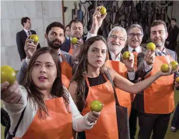  ?? — AFP ?? Opposition members of the Brazilian Congress stage a protest at the National Congress in Brasilia while President Jair Bolsonaro arrives to hand over a draft of a pension reform bill on Wednesday.