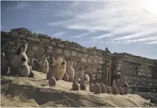  ?? AP; AFP; EPA ?? Clockwise from top, artefacts Zahi Hawass and his team unearthed at Saqqara include wooden sarcophagi, an ornately decorated stone stele, or block, and pottery from the funerary temple of Queen Naert, from as far back as 4,300 years ago