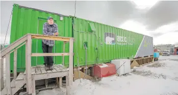  ??  ?? Joe Carr works at the hydroponic­s farm — located inside this shipping crate — owned by a local Alaska Native corporatio­n in Kotzebue, Alaska. The indoor setup allows vegetable farming above the Arctic Circle.