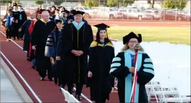  ?? PHOTO FOR THE RECORDER BY JAIME A. HUNT ?? Dr. Claudia Habib, President of Portervill­e College, Primavera Arvizu, V.P. Student Services, and other PC College faculty lead the 94th commenceme­nt procession into Jamison Stadium on Friday, May 13.