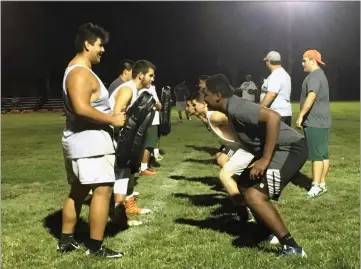  ?? RECORDER PHOTO BY NAYIRAH DOSU ?? Players workout in position specific drills a little after midnight during the punt teams portion of practice at Portervill­e High School.