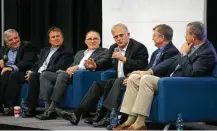  ??  ?? Dave Wolf, center, who made four flights into space, speaks Thursday as part of a SpaceCom panel of astronauts who have become entreprene­urs.