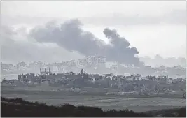  ?? OHAD ZWIGENBERG/ASSOCIATED PRESS ?? Smoke rises following an Israeli airstrike in the Gaza Strip on Monday. Israel has told Palestinia­n civilians to move farther south.