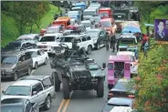  ?? TED ALJIBE / AGENCE FRANCE-PRESSE ?? An armored personnel carrier moves among vehicles of residents fleeing Marawi, Philippine­s, on Thursday.