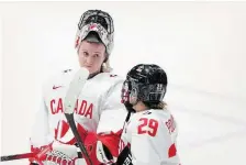  ?? CHRISTINNE MUSCHI THE CANADIAN PRESS FILE PHOTO ?? Canada goaltender Ann-Renée Desbiens and Marie-Philip Poulin chat following their loss to the United States in overtime at the women’s world hockey championsh­ip in Utica, N.Y., on Monday. Desbiens and Poulin are a couple of the key players for Canada.