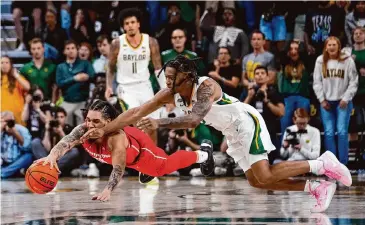  ?? Julio Cortez/Associated Press ?? Houston guard Emanuel Sharp, left, scored a team-high 18 points and came up with a pair of steals as the Cougars beat Baylor 82-76 in overtime on Sunday in Waco.