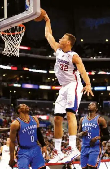  ??  ?? Los Angeles Clippers forward Blake Griffin dunks over Oklahoma City Thunder's Russell Westbrook, and Reggie Jackson during the first half of an NBA basketball game in Los Angeles.