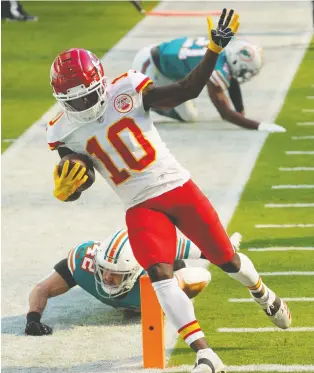  ?? MARK BROWN/ GETTY IMAGES ?? Tyreek Hill of the Kansas City Chiefs scores one of his two touchdown against the Dolphins during the second quarter of the game at Hard Rock Stadium on Sunday in Miami Gardens, Florida.