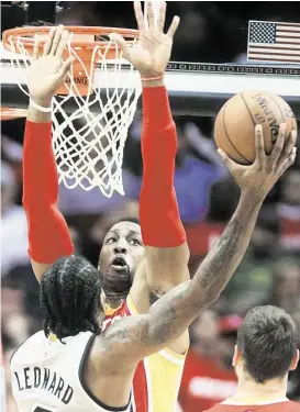  ?? Cody Duty / Houston Chronicle ?? Rockets center Dwight Howard, here taking the basket away from Spurs forward Kawhi Leonard, is one of the best in the NBA at contesting or discouragi­ng shots.