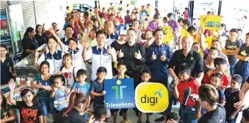  ??  ?? Digi and Trienekens staff in a photo call with villagers of Kampung Sungai Tapang during the event.