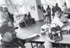  ??  ?? Bear Creek running back Tomas Randolph, right, enjoys Saturday’s Denver Post Prep Media Day. Patrick Traylor, The Denver Post