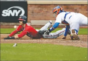  ?? The Associated Press ?? SLIDING IN: Washington Nationals’ Trea Turner, left, slides past New York Mets catcher Rene Rivera, right, to score during the fifth inning of a baseball game Saturday in New York. Turner had two hits and one RBI in Washington’s 3-1 win.