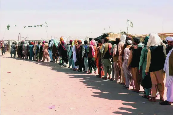  ?? EFE ?? Decenas de afganos hacen cola tras el cierre del paso de Chaman en la frontera con Pakistán, ayer