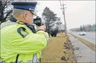  ?? NIKKI SULLIVAN/CAPE BRETON POST ?? Sgt. Joe Farrell of the Cape Breton Regional Police Service traffic unit points a lidar device at cars travelling on Grand Lake Road. Officers are on the lookout for speeding and aggressive driving offences, which tend to increase as weather gets warmer.