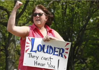  ?? Darrell Sapp/Post-Gazette ?? Pamela Huff, of Chippewa, Beaver County, cheers to the honking horns of support as she attends a Republican-supported rally in defiance of Gov. Tom Wolf’s orders Friday.