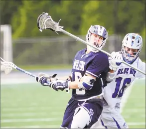  ?? Bob Luckey Jr. / Hearst Connecticu­t Media ?? Darien’s Charlie Olsen defends against Wilton’s Andrew Luciano during the closing minutes of the Blue Wave’s 11-10 victory on Saturday in Darien.